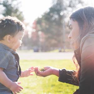 Woman and toddler in grassy field