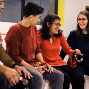A photo of  a group practicing mobility by moving an instrument with bells